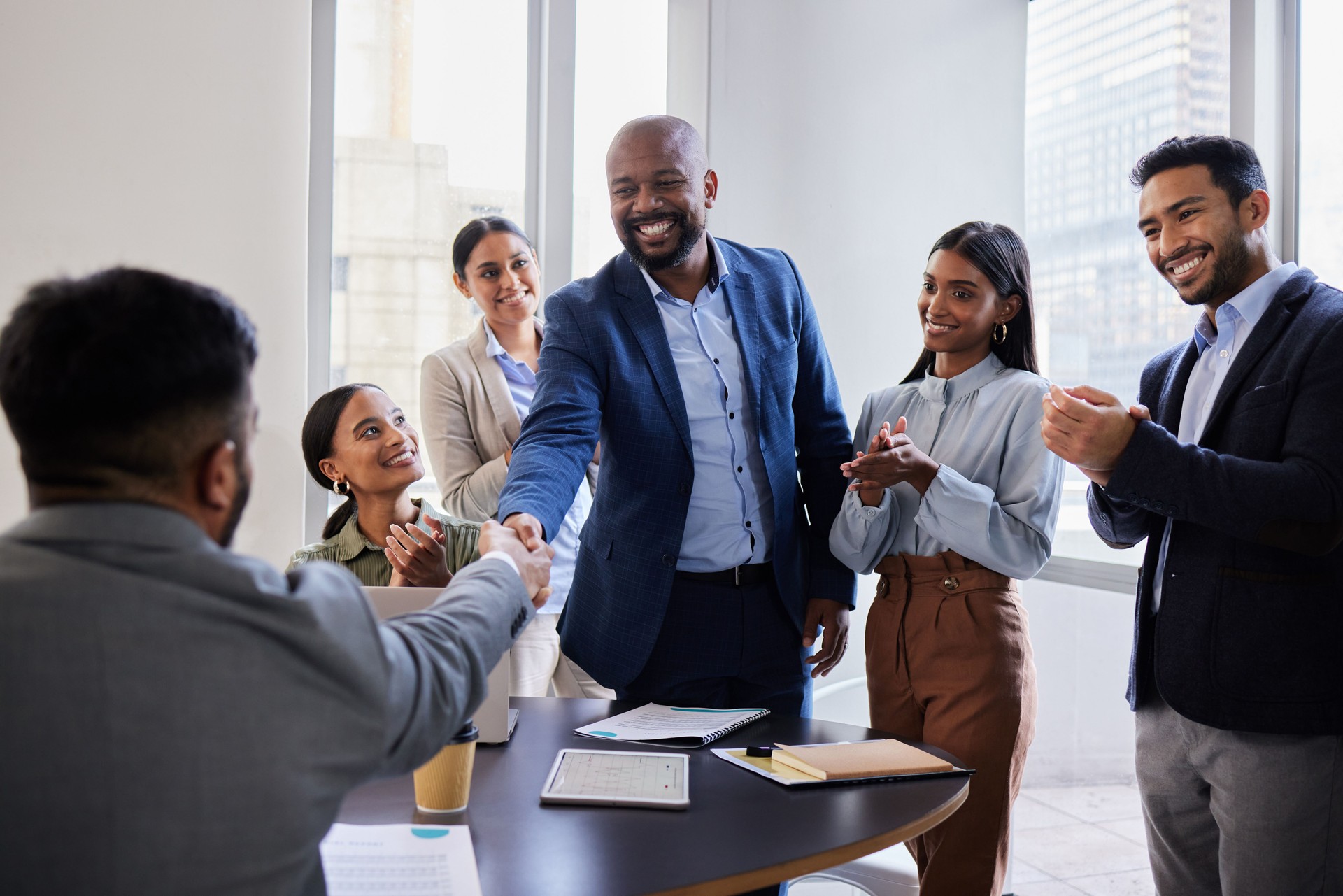 Shot of two business people shaking hands during a meeting